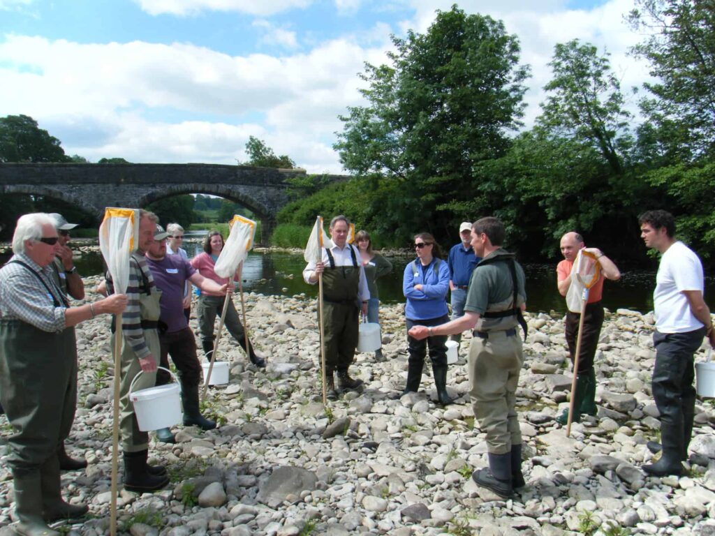 Volunteers taking part in riverfly training, which teaches them how to identify various river insects
