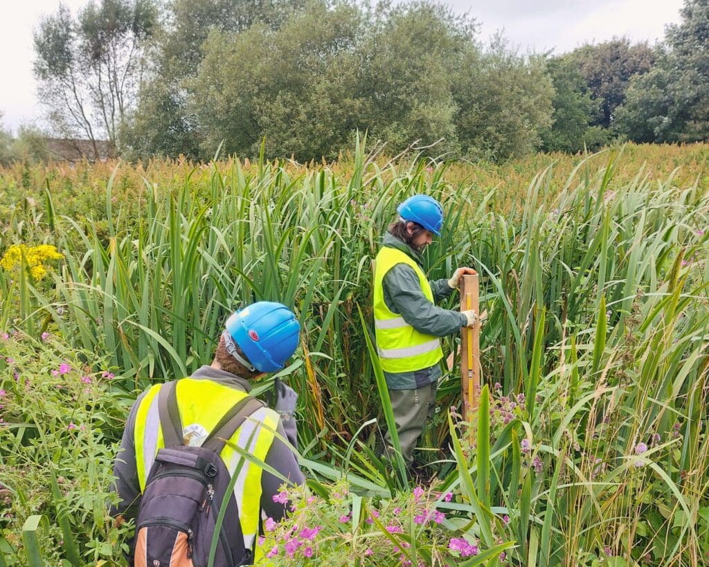 Staff installing Natural Flood Management monitoring stations close to Blacksnape.
